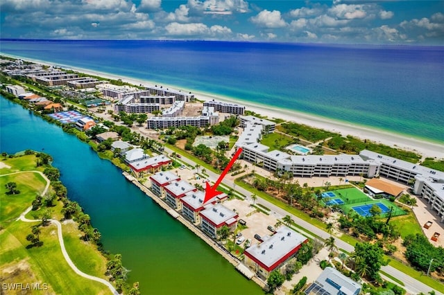 drone / aerial view with a beach view and a water view