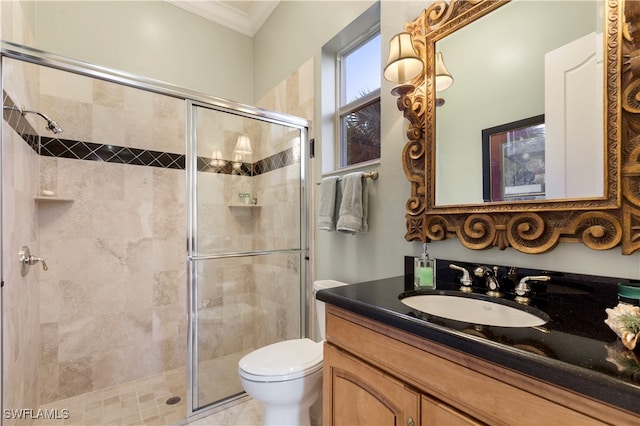 bathroom featuring toilet, crown molding, walk in shower, and vanity