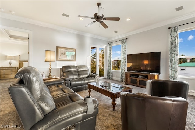 living room featuring ceiling fan, ornamental molding, and carpet floors