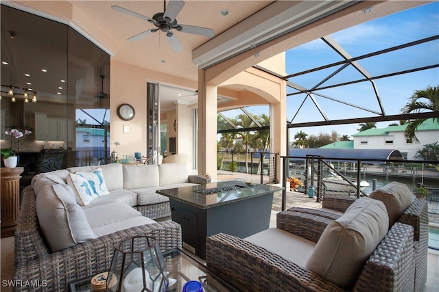 view of patio featuring outdoor lounge area, glass enclosure, and ceiling fan