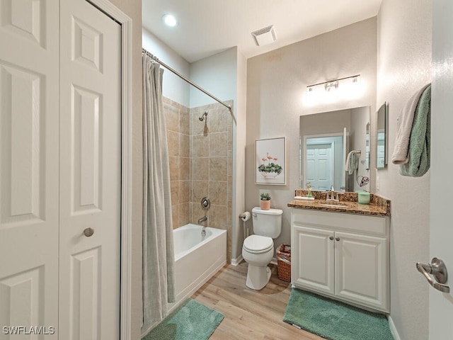 full bathroom featuring vanity, toilet, wood-type flooring, and shower / bath combo with shower curtain