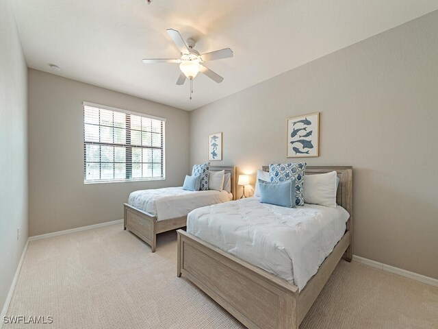 bedroom featuring ceiling fan and light colored carpet