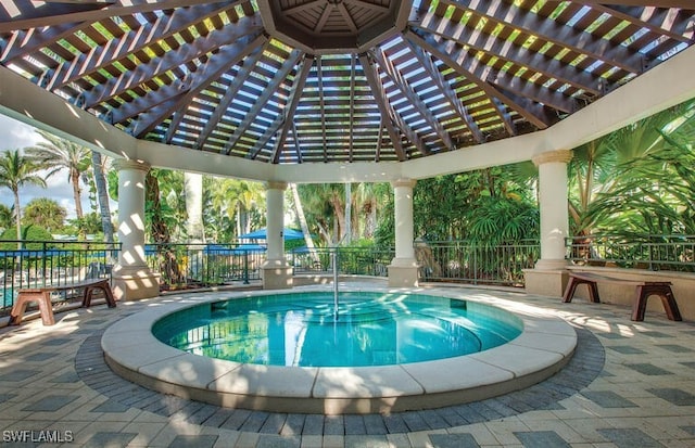 view of pool featuring a gazebo and an in ground hot tub