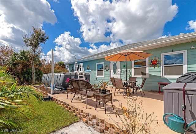 rear view of property featuring a patio area