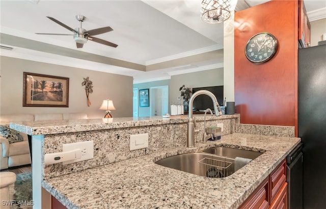 kitchen with sink, a raised ceiling, kitchen peninsula, stainless steel dishwasher, and crown molding