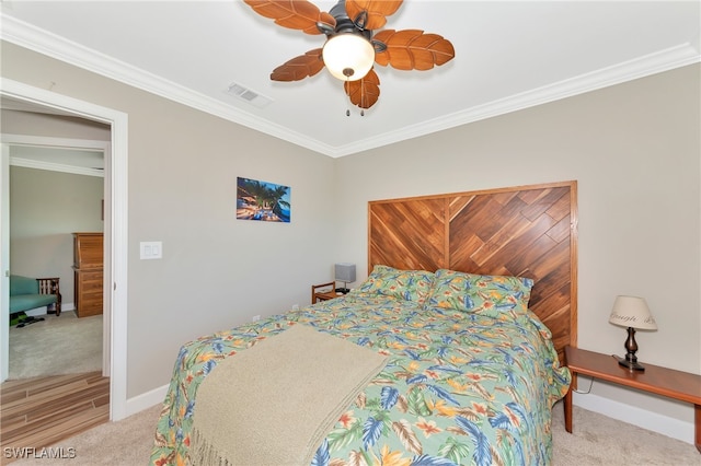 bedroom with light carpet, crown molding, and ceiling fan