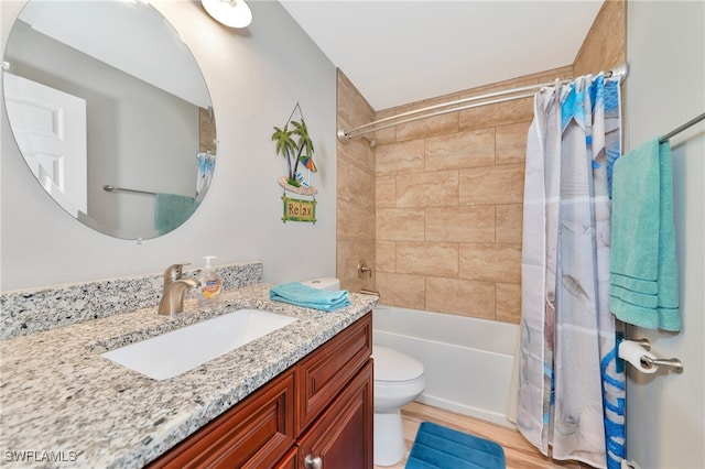 full bathroom with shower / tub combo with curtain, vanity, wood-type flooring, and toilet