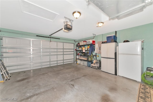 garage featuring a garage door opener and white refrigerator