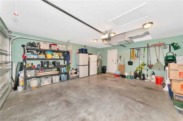 garage featuring a garage door opener and white refrigerator