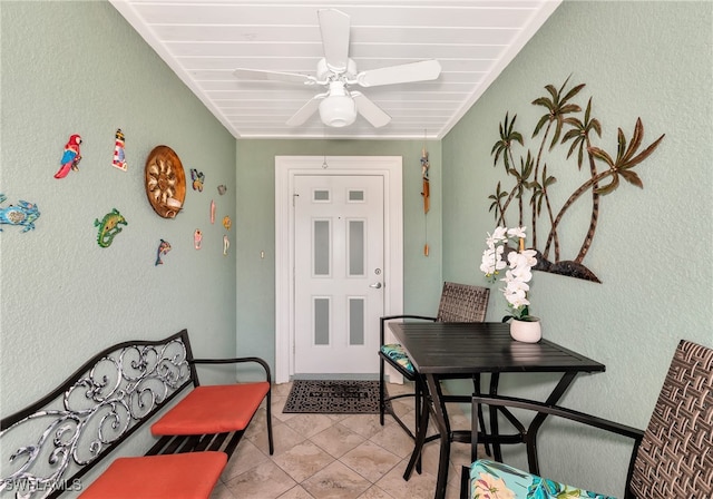 tiled foyer with ceiling fan