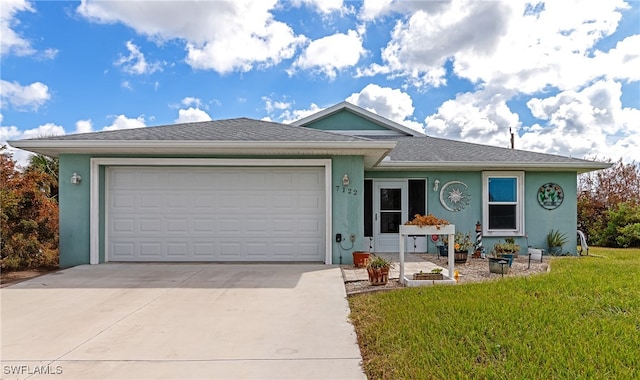 view of front of home featuring a front yard and a garage