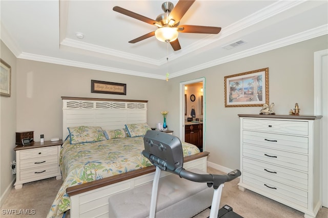 carpeted bedroom with ornamental molding, ensuite bathroom, a raised ceiling, and ceiling fan