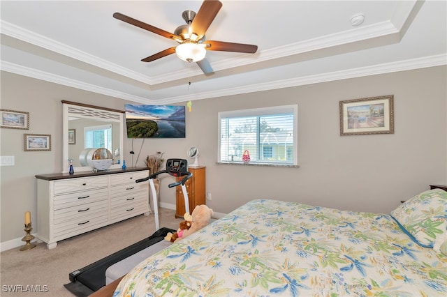 bedroom with ceiling fan, light carpet, a raised ceiling, and crown molding