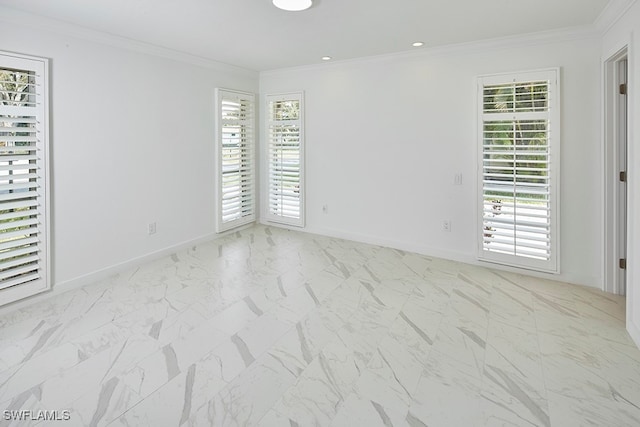 empty room featuring crown molding and a wealth of natural light