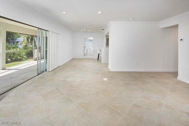 unfurnished room with crown molding