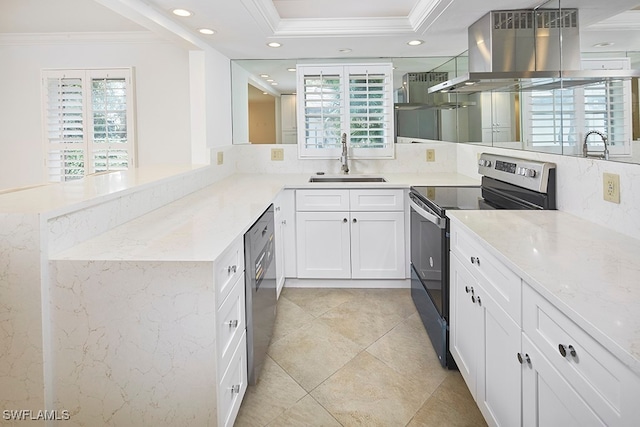 kitchen featuring island exhaust hood, appliances with stainless steel finishes, a wealth of natural light, and kitchen peninsula