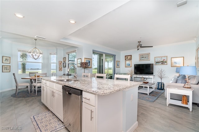 kitchen with sink, hanging light fixtures, stainless steel dishwasher, white cabinets, and a center island with sink