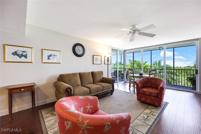 living room featuring dark hardwood / wood-style floors, a wall of windows, and ceiling fan