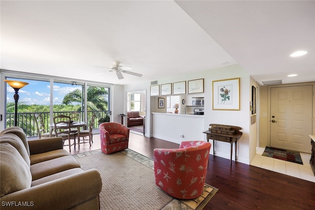 living room with hardwood / wood-style floors and ceiling fan