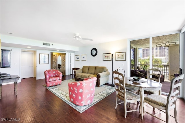 living room with ceiling fan and dark hardwood / wood-style flooring