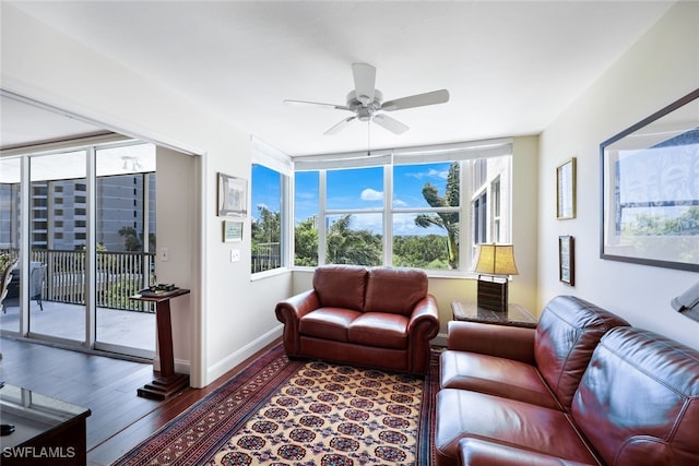 living room featuring ceiling fan and dark hardwood / wood-style flooring