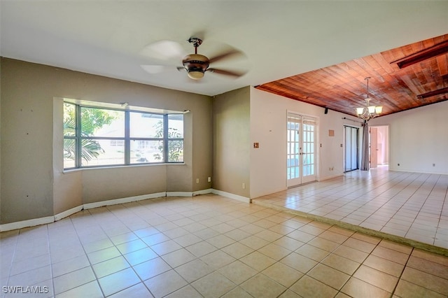 empty room with ceiling fan with notable chandelier, light tile patterned floors, and wooden ceiling