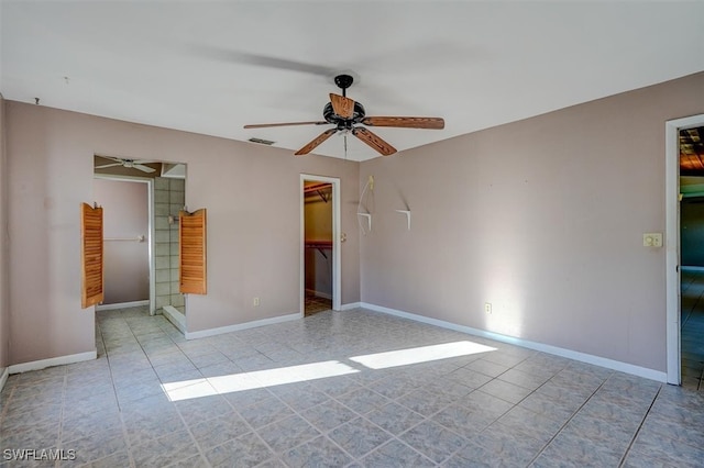 unfurnished room with light tile patterned floors and ceiling fan