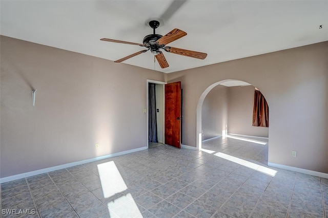 tiled empty room with ceiling fan