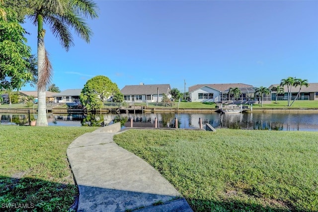 surrounding community with a yard and a water view