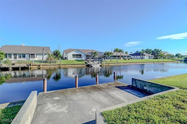 dock area featuring a water view and a yard