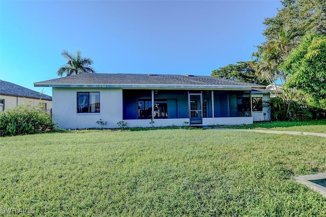 view of front of home with a front yard and a sunroom