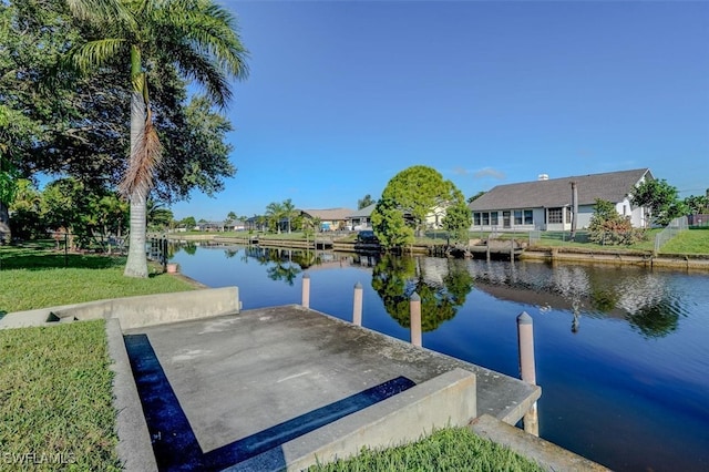 dock area with a yard and a water view