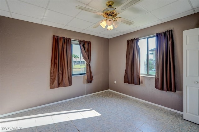 unfurnished room with a paneled ceiling and ceiling fan