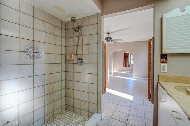 bathroom with vanity, ceiling fan, tiled shower, and tile patterned flooring