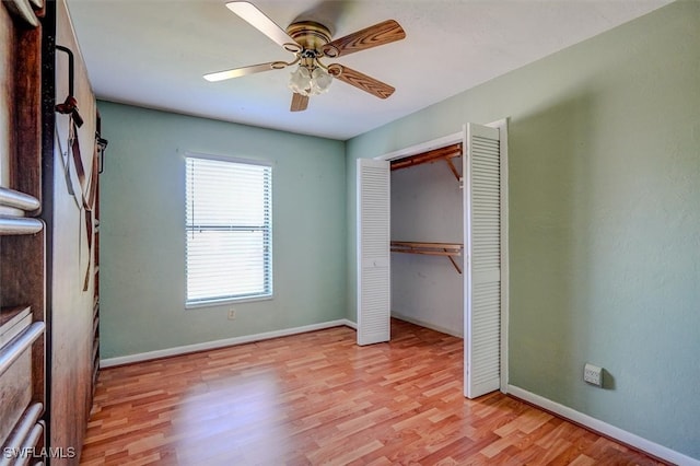 unfurnished bedroom featuring light hardwood / wood-style floors, a closet, and ceiling fan