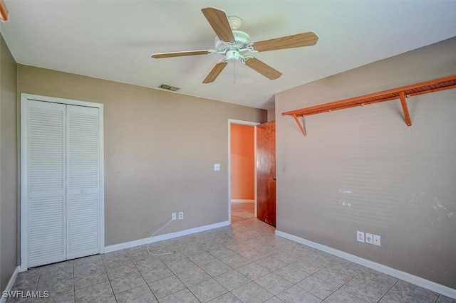 unfurnished bedroom featuring light tile patterned floors, a closet, and ceiling fan