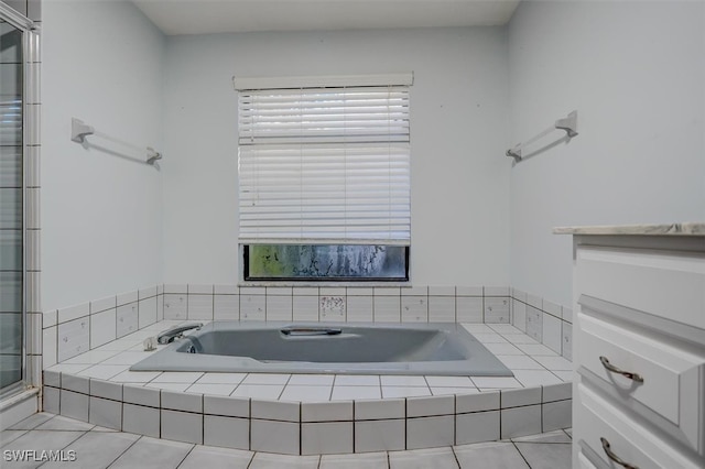 bathroom with separate shower and tub and tile patterned floors