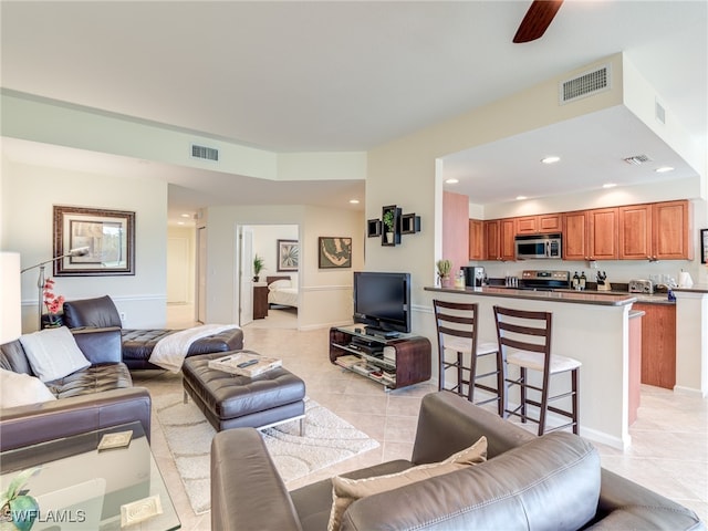 living room with ceiling fan and light tile patterned floors