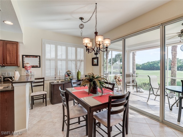 dining space with sink, a chandelier, and light tile patterned flooring