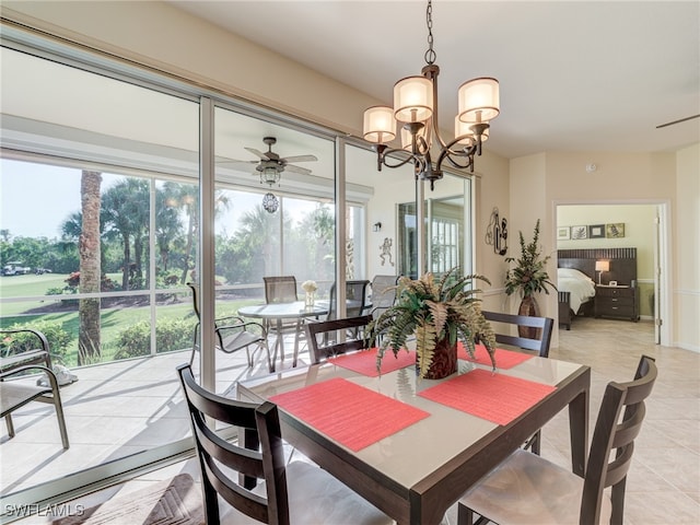 tiled dining space featuring ceiling fan with notable chandelier