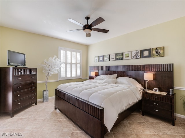 tiled bedroom featuring ceiling fan