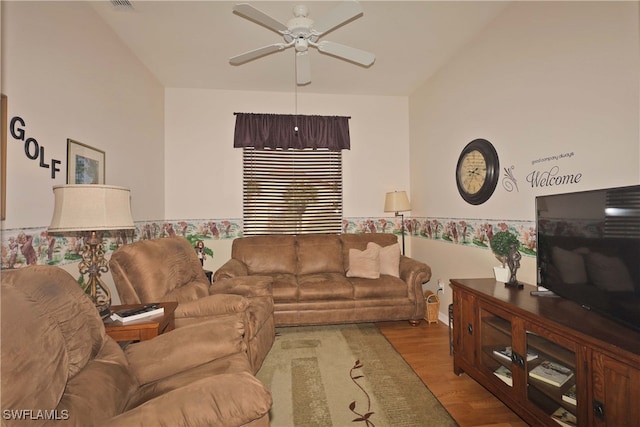 living room with ceiling fan, light hardwood / wood-style flooring, and lofted ceiling