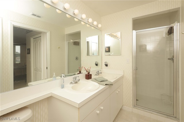 bathroom with tile patterned floors, vanity, and walk in shower