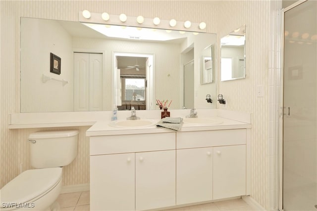 bathroom with tile patterned flooring, vanity, toilet, and a shower with shower door