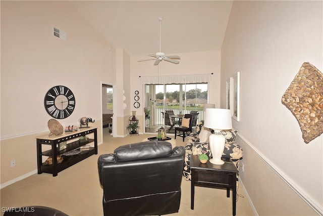 carpeted living room featuring ceiling fan and high vaulted ceiling