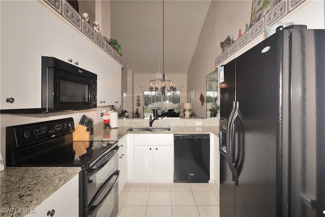 kitchen with vaulted ceiling, sink, black appliances, a notable chandelier, and white cabinetry