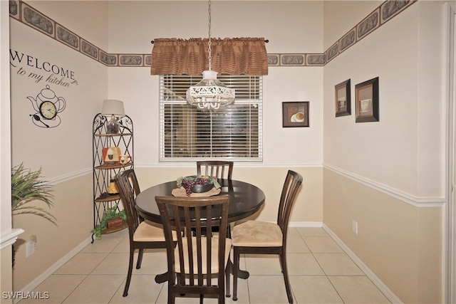 dining area featuring a notable chandelier and light tile patterned floors