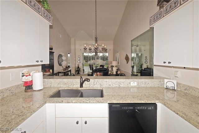 kitchen featuring light stone countertops, vaulted ceiling, sink, white cabinets, and black dishwasher