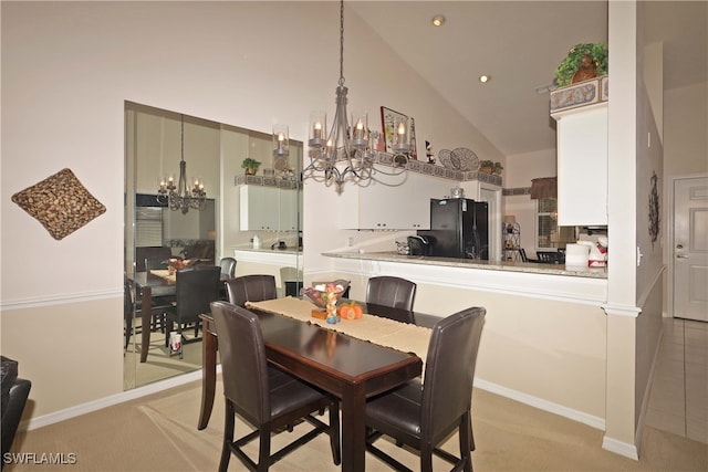 carpeted dining area with high vaulted ceiling and a chandelier