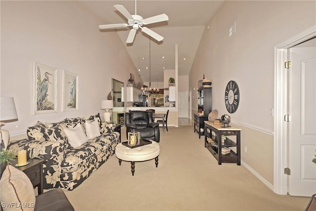 living room with carpet floors, ceiling fan, and high vaulted ceiling